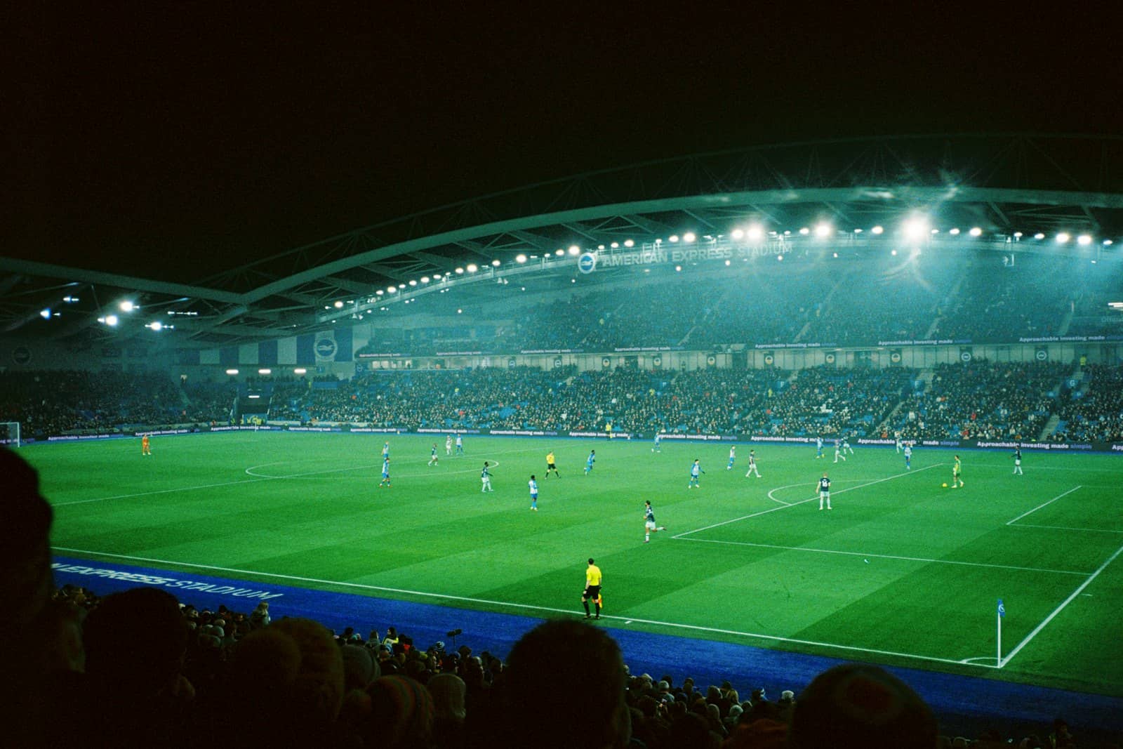 A football pitch under floodlights at night