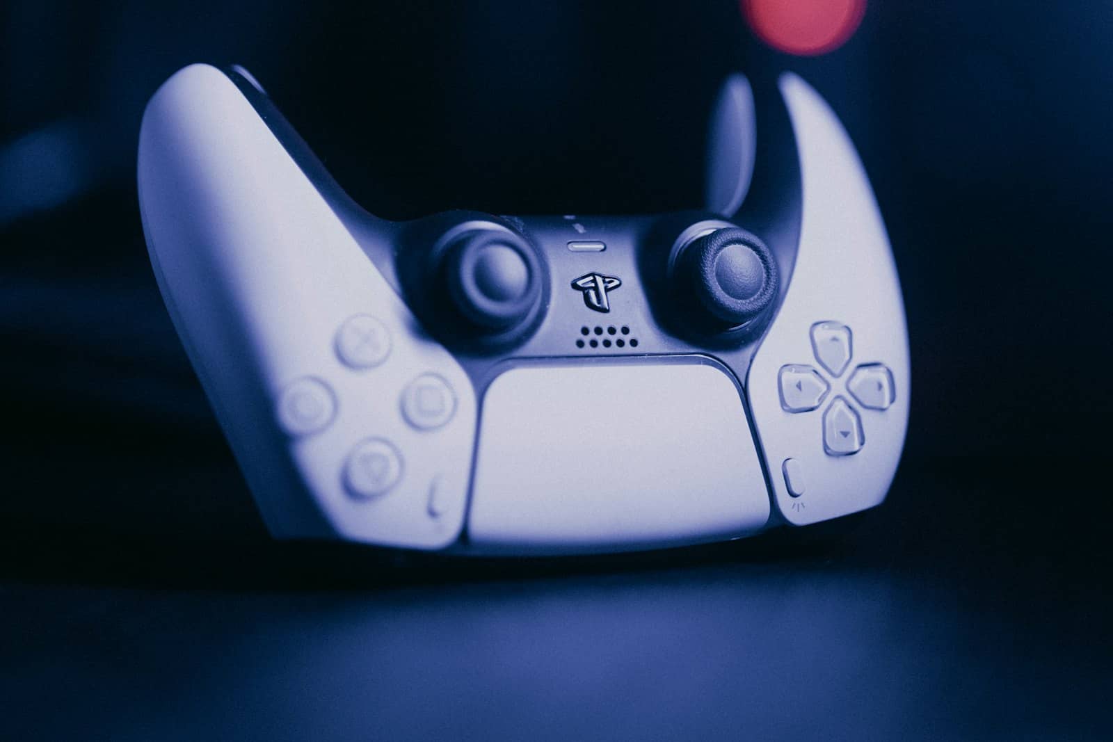 A game controller lit by a screen at night